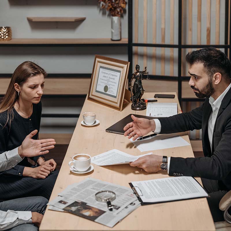 A solicitor speaking directly with a client across the desk